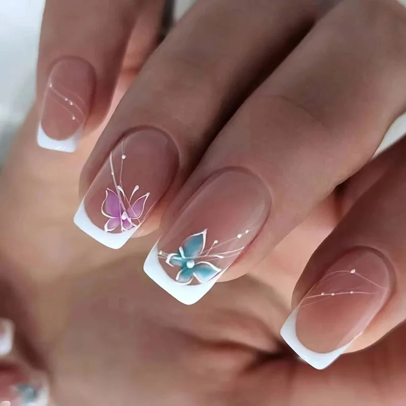 Sheer Nude Pink French Tip Nails With Purple and Teal Butterflies