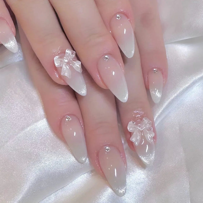 Sheer Nude Pink French Tip Press On Nails with Raised Clear Bows and Rhinestones