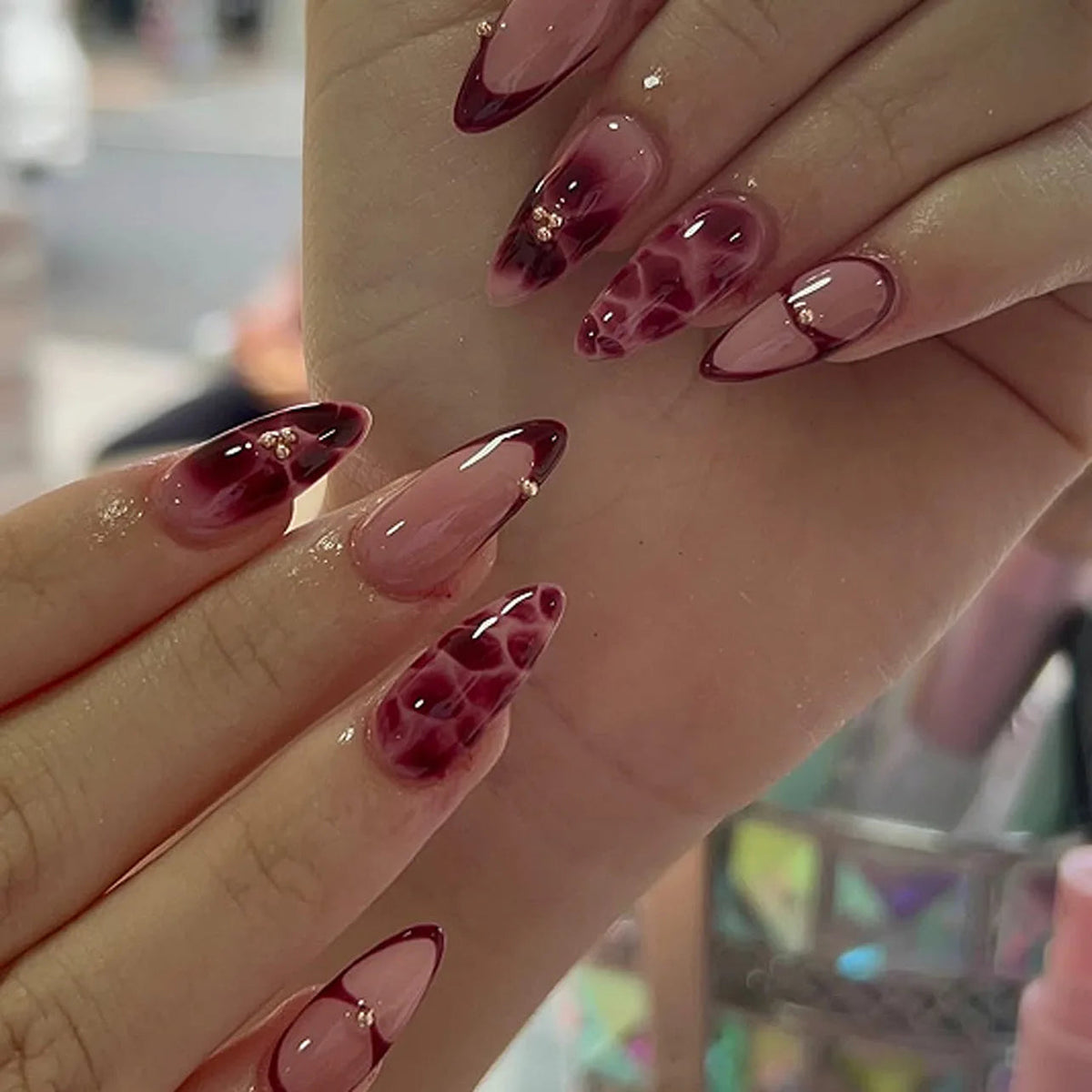 Sheer Pink and Burgundy French Tip Nails with Marbled Accents
