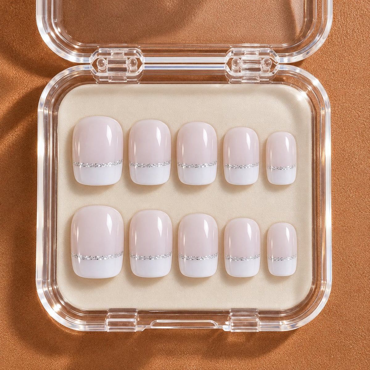 Sheer Pink French Tip Nail Set with Fine Silver Glitter Accents in clear acrylic storage box