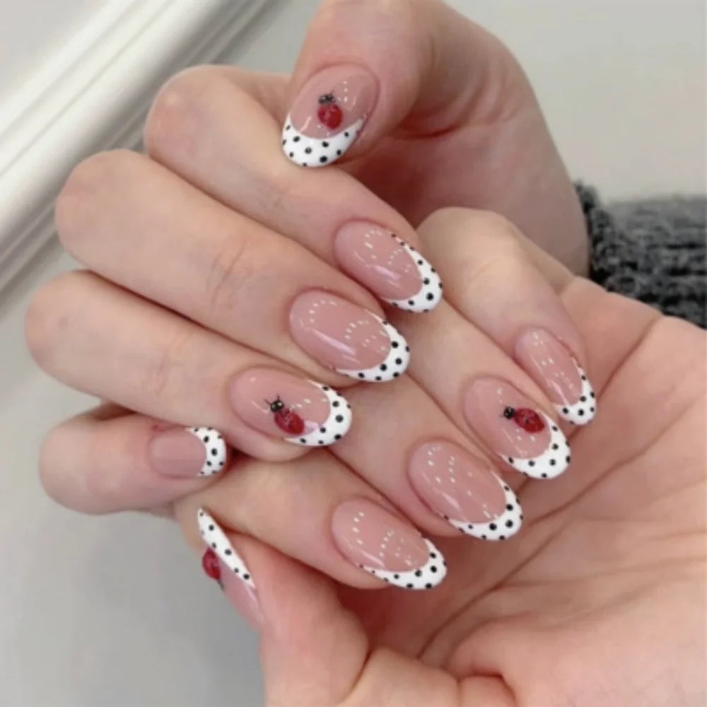 Sheer Pink French Tip Nails with Black Polka Dots and Ladybug Accents