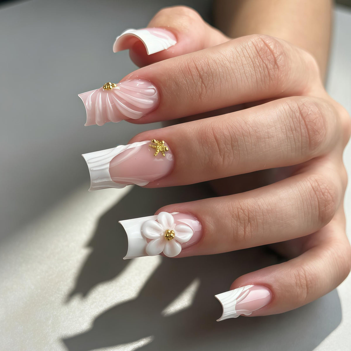 Sheer Pink French Tip Wedding Nails with White Sculpted Flowers and Gold Accents