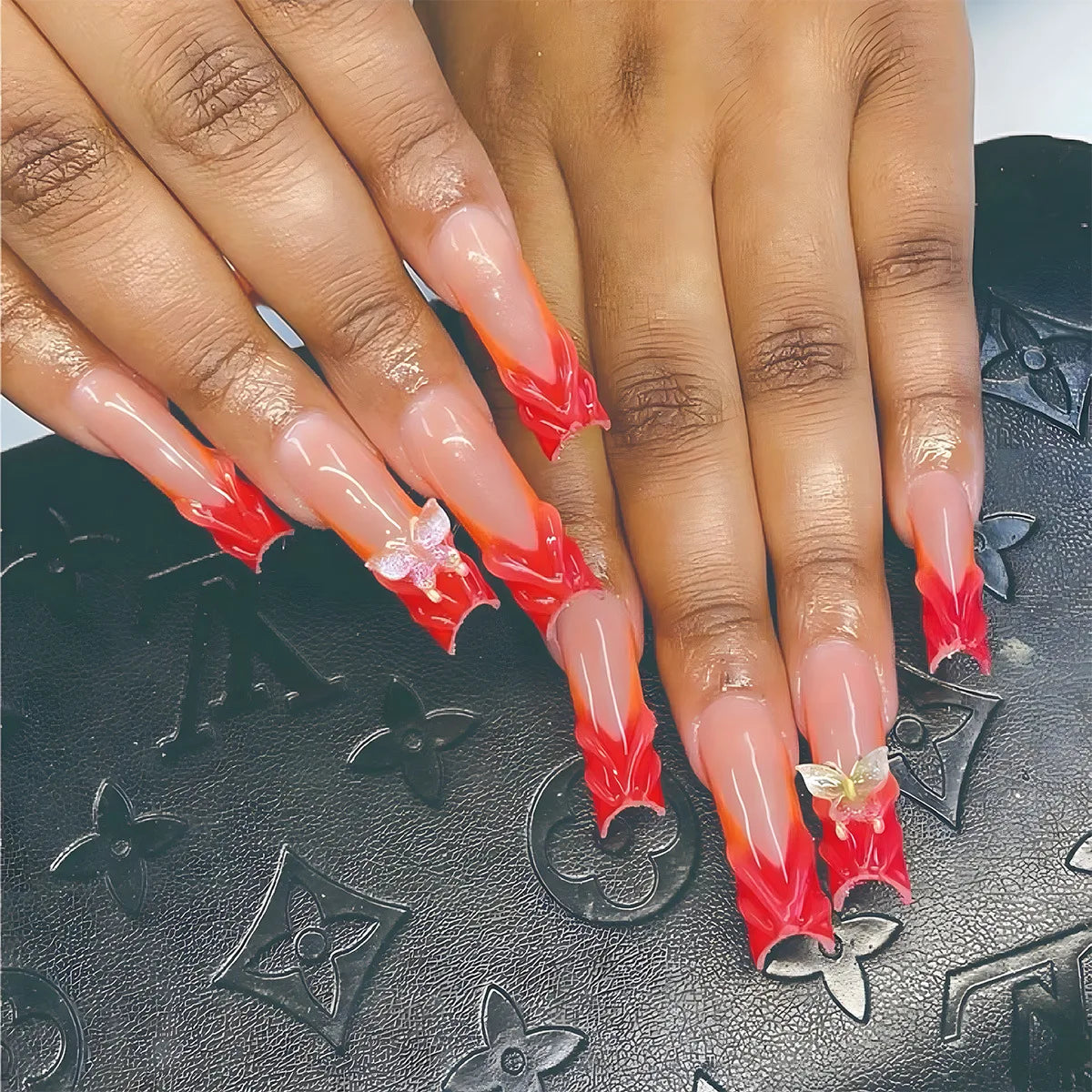 Sheer Pink Nails with Vivid Red Sculpted Tips and Butterfly Accents