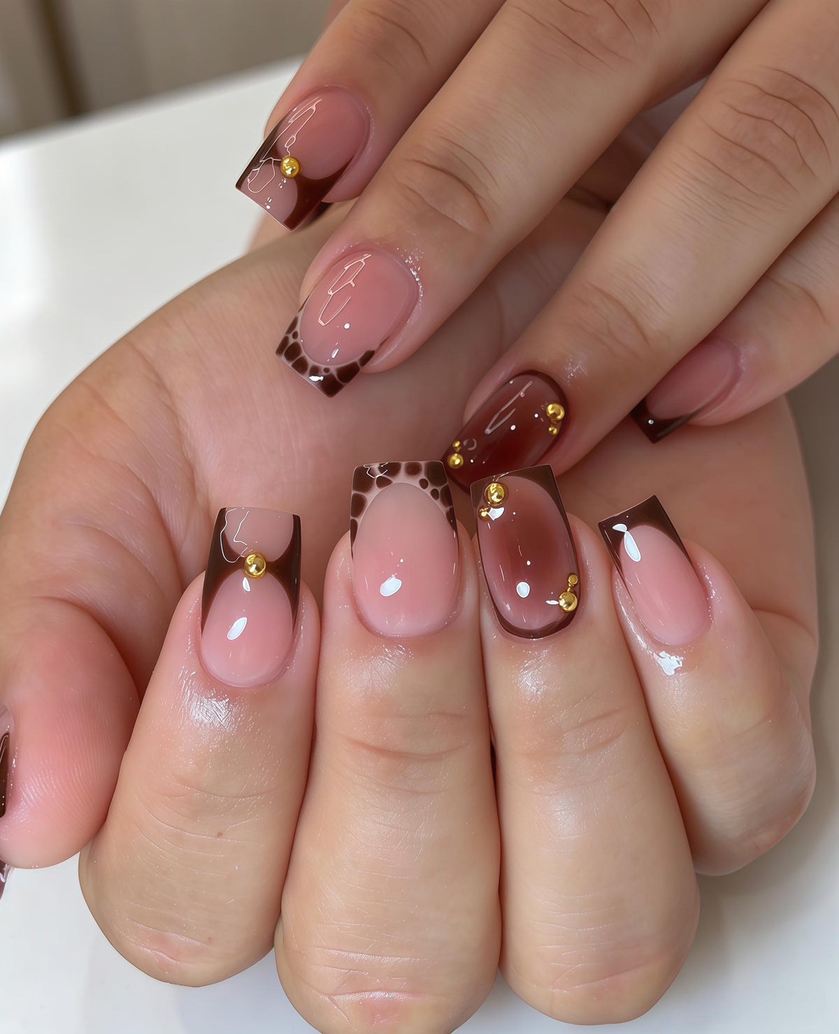Sheer Pink Nude Nails With Brown French Tips and Gold Bead Details