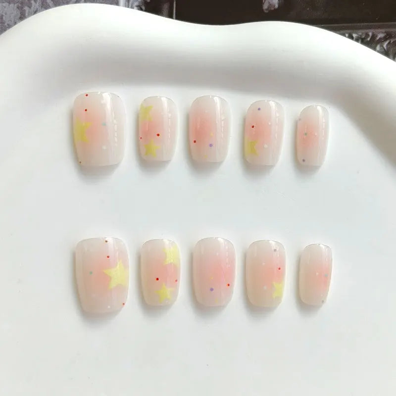 Sheer Pink Peach Nails with Yellow Stars and Blush Details