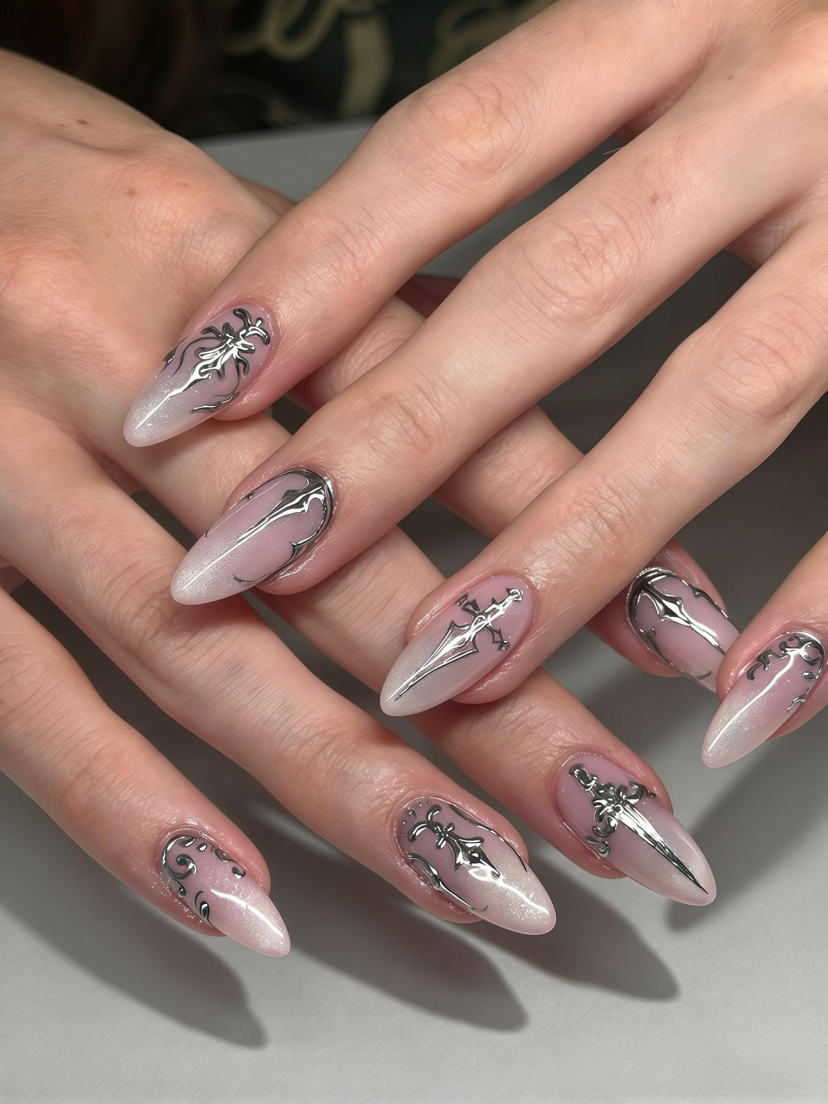 Sheer Pink Shimmer Nails With Silver Gothic Sword Designs
