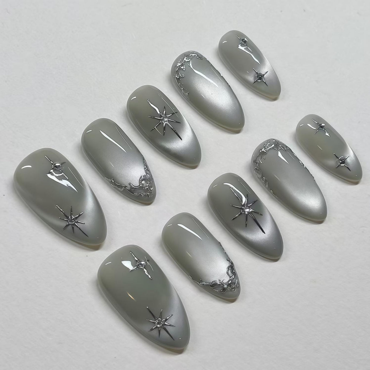 Silver Gray Cat Eye Nails With Starbursts and Raised Metallic Trim
