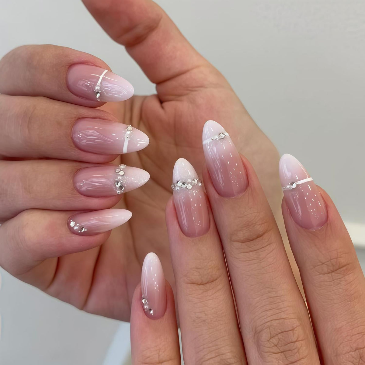 Soft Pink Ombré French Tip Nails With Rhinestone and Pearl Accents