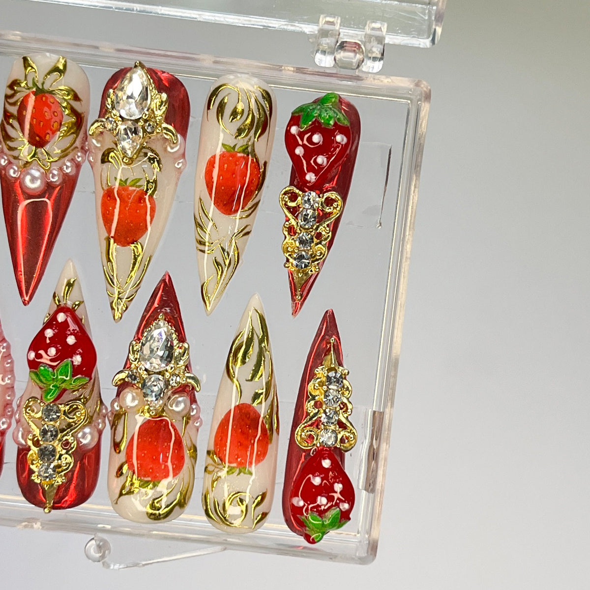 Strawberry Press-On Nail Set With Gold Embellishments and Rhinestones