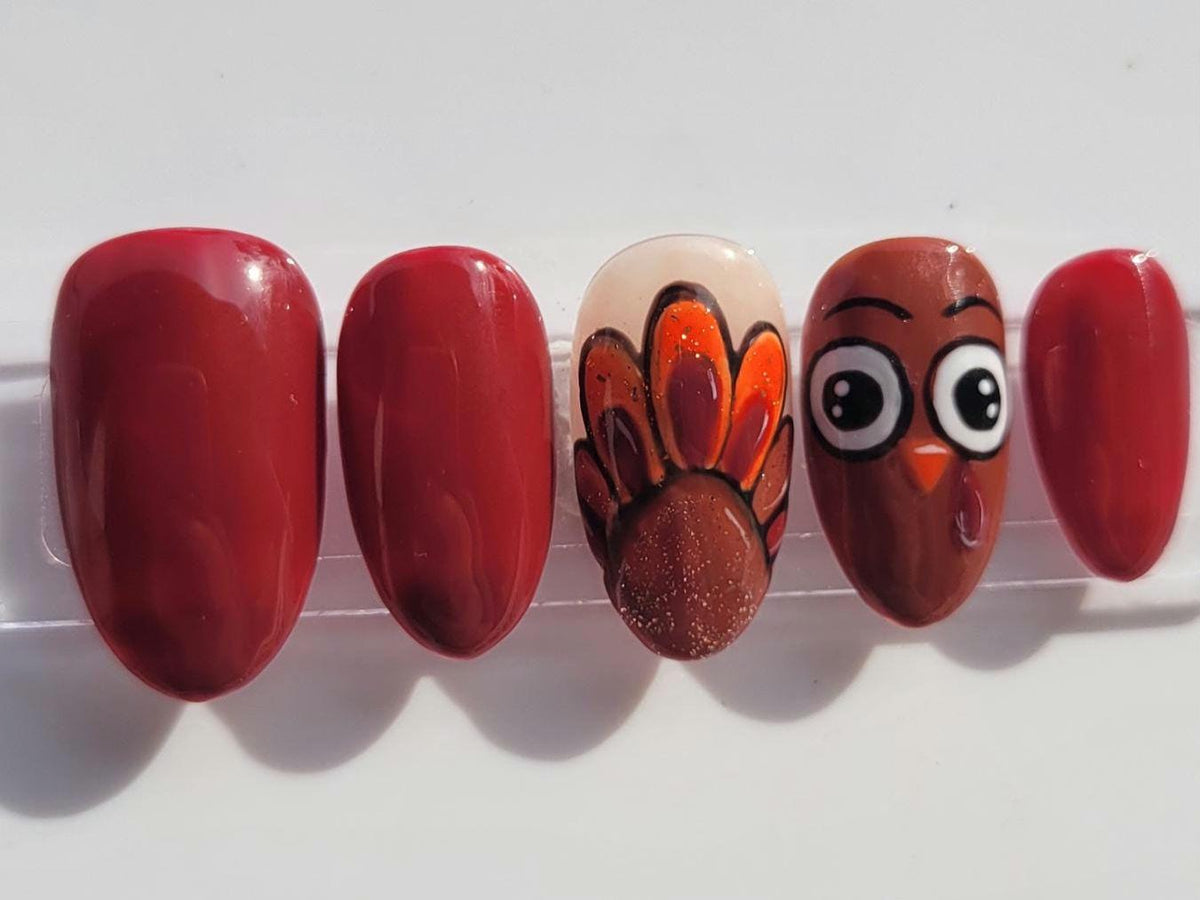 Thanksgiving Turkey Nails in Glossy Maroon with Painted Feather and Face Accents