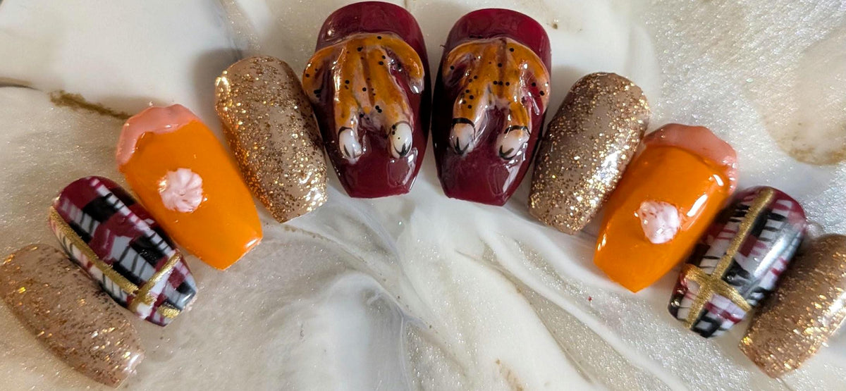 Thanksgiving Turkey Nails With Burgundy Plaid, Orange Pie Details, and Gold Glitter