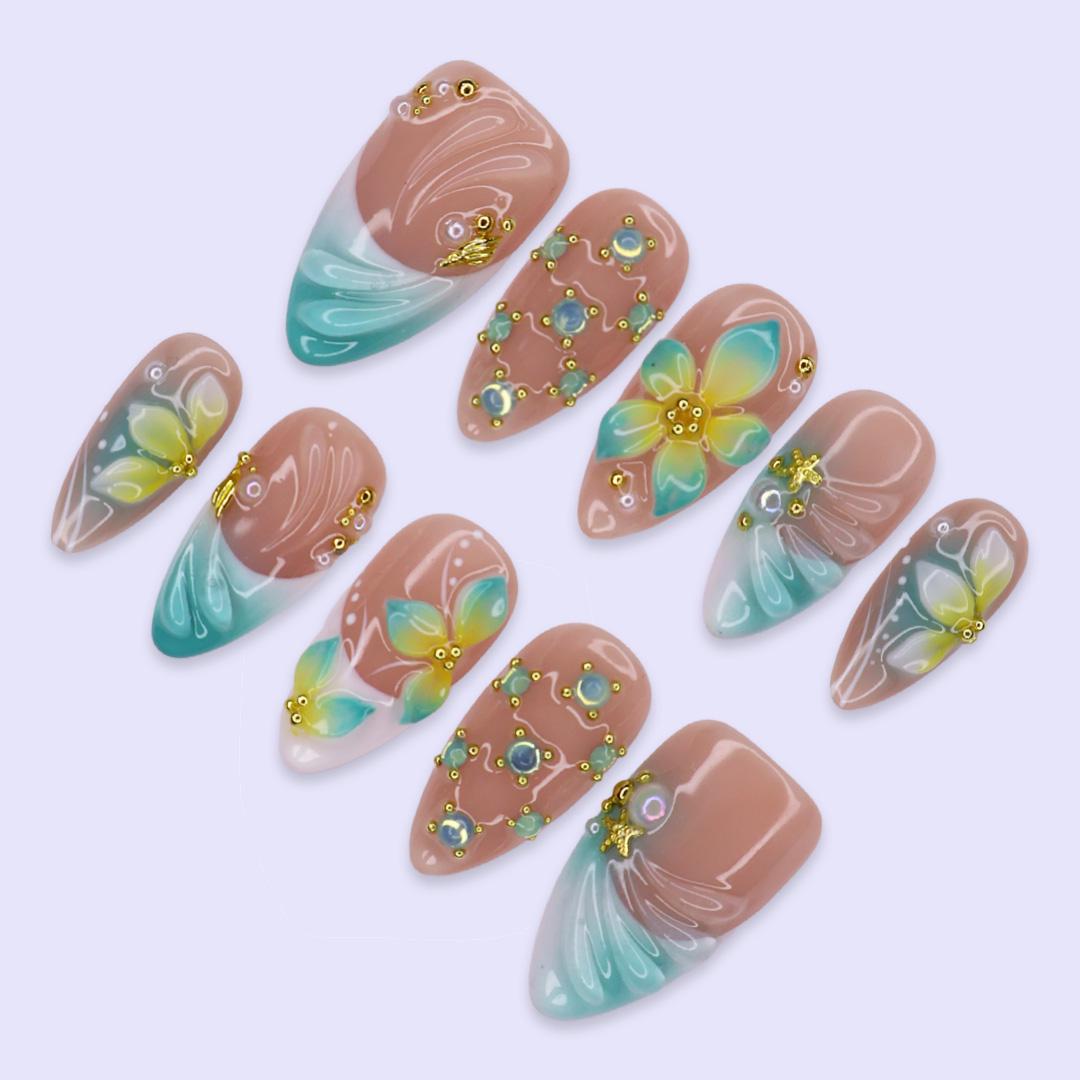 Tropical Flower and Shell Line-Art Nails with Aqua Tips and Gold-Toned Details