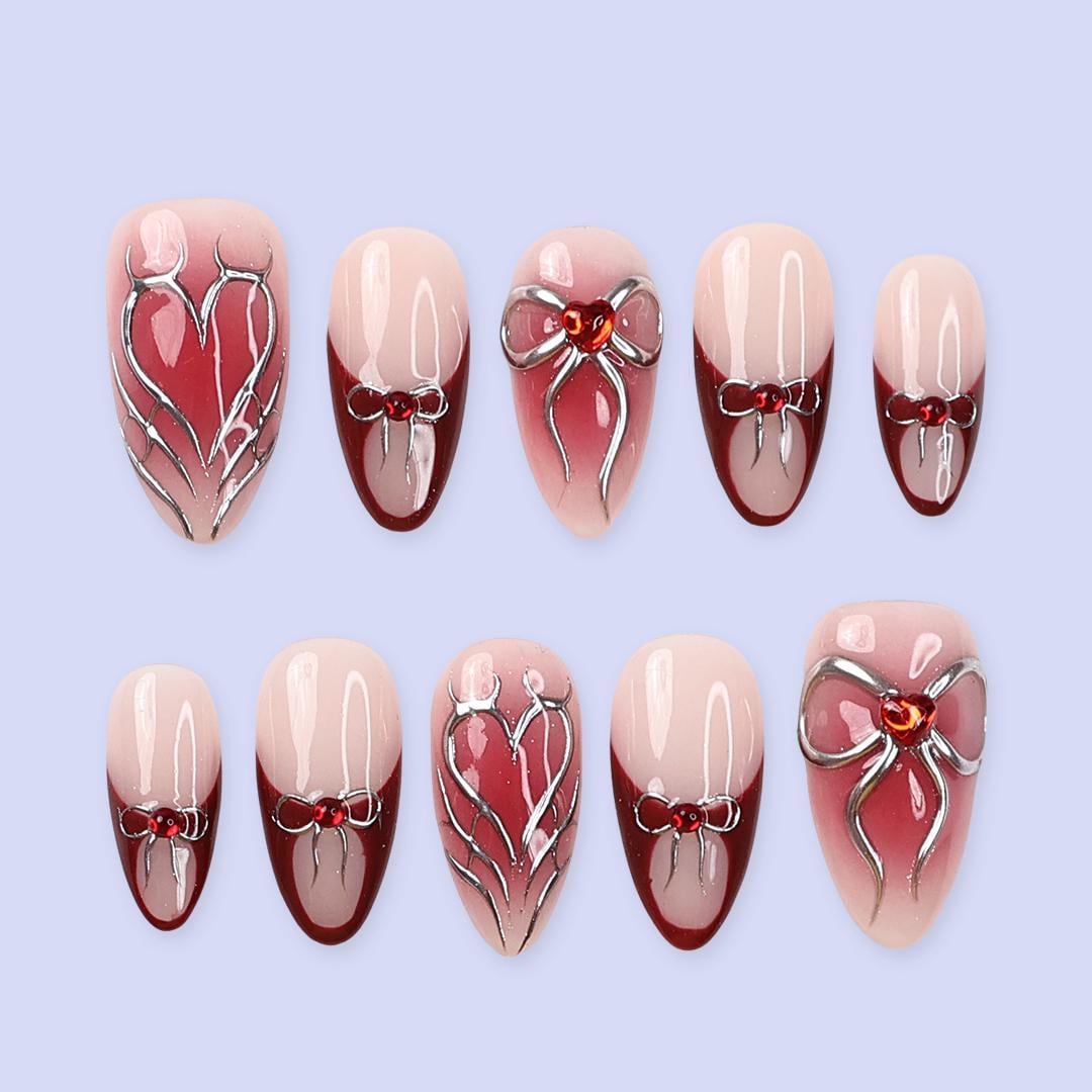 Valentine Nude Pink and Red French Tip Nails with Silver Bow and Heart Motifs