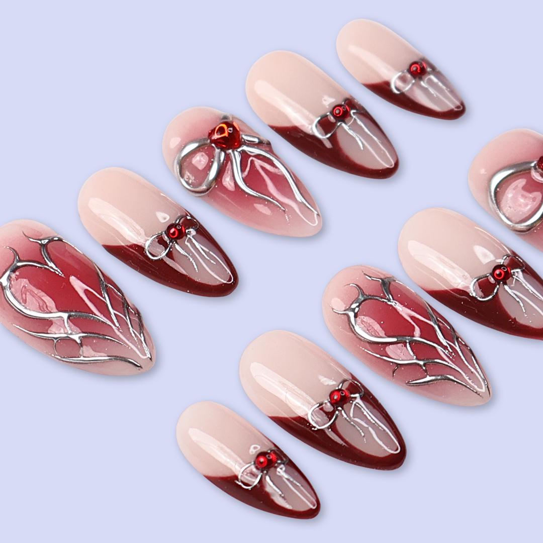 Valentine Nude Pink and Red French Tip Nails with Silver Bow and Heart Motifs