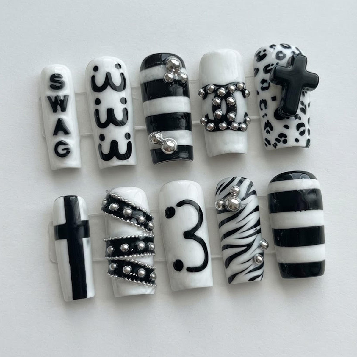 Y2K Black and White Animal Print Nails with Raised Crosses and Silver Chain Details