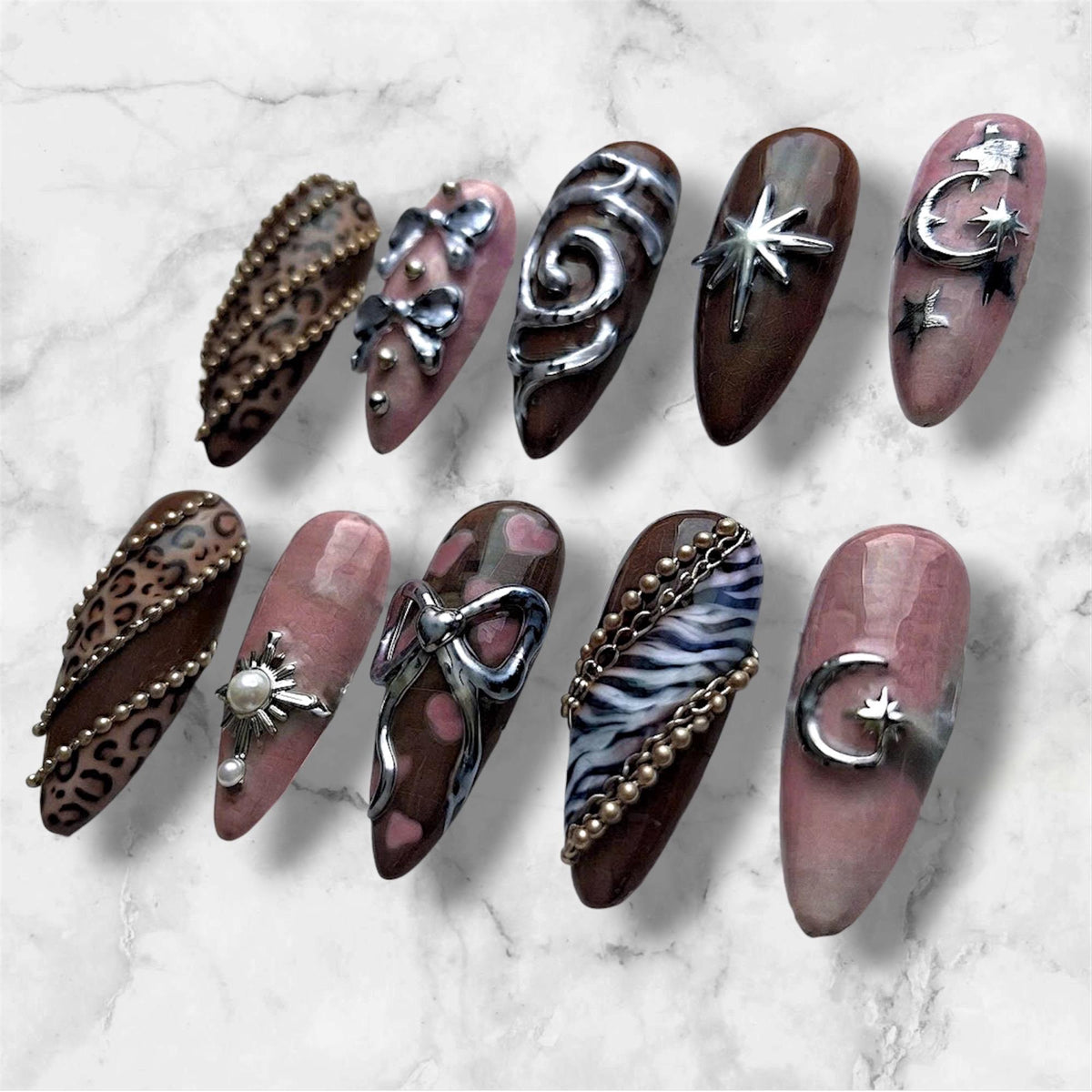 Y2K Brown and Pink Leopard Print Nails with Silver Bows and Celestial Charms