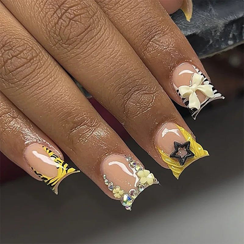 Yellow French Tip Nails with 3D White Flowers, Rhinestones and Black Star Charm